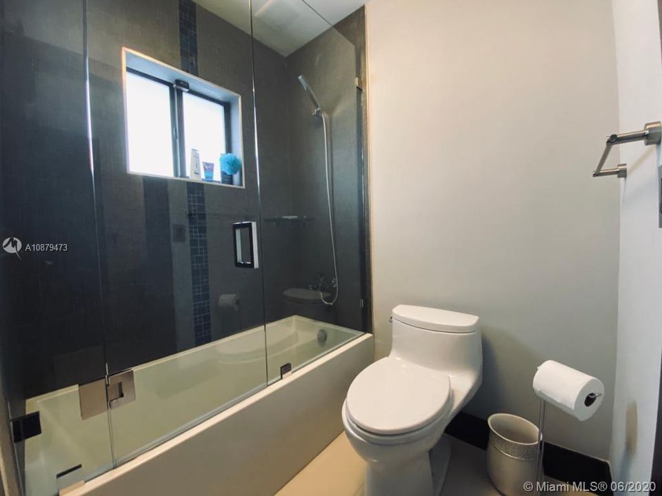 Third full bathroom with separated tub/toilet area.