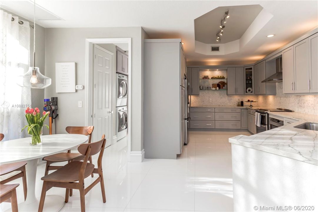 Kitchen and breakfast nook leading to laundry.