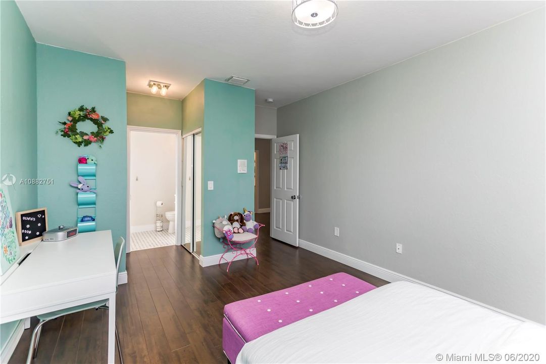 2nd master bedroom with view of private bathroom