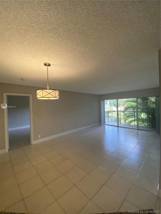 DINNING AND LIVING AREA... TILE THROUGHOUT ..UNIT IS FRESHLY PAINTED ,TILE IS BEING PROFESSIONALLY POLISH AND BRAND NEW LIGHT FIXTURES.