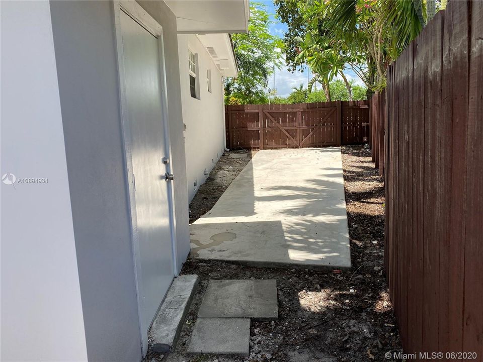 side yard with double doors and cement slab for Boat/RV