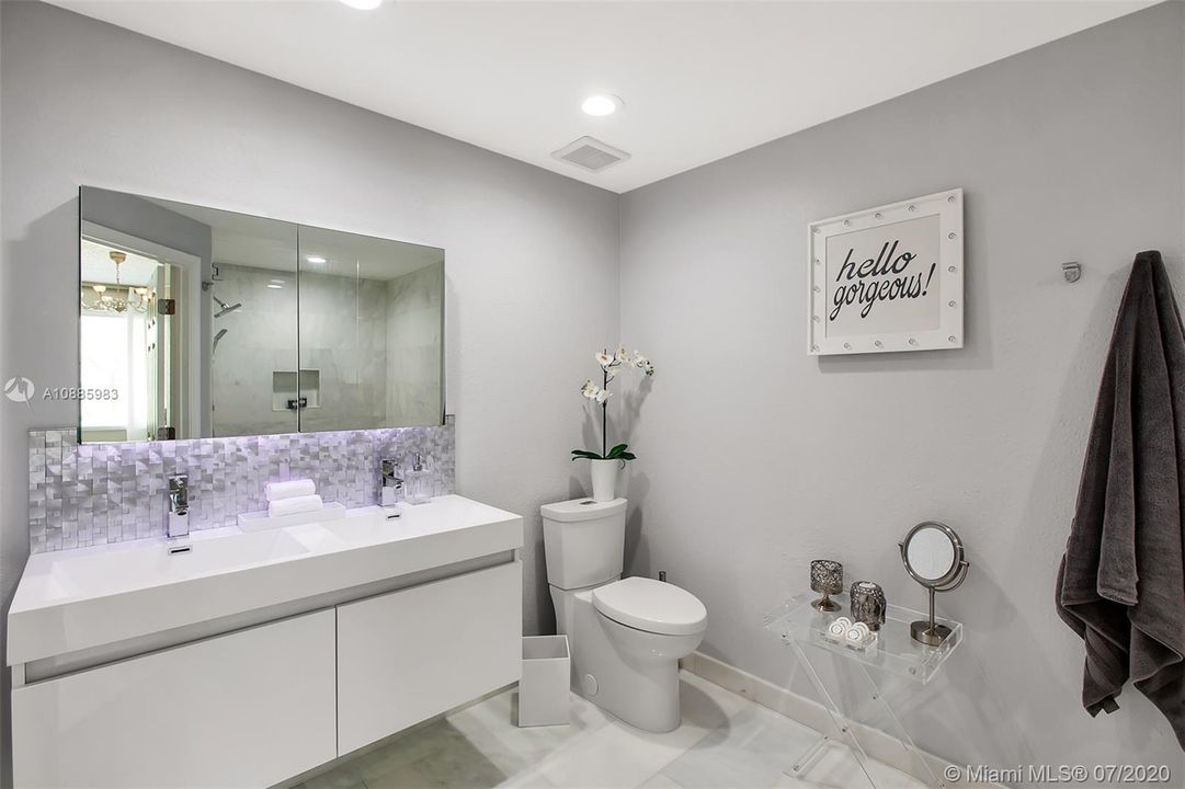 dual sinks with built in storage behind double mirrors