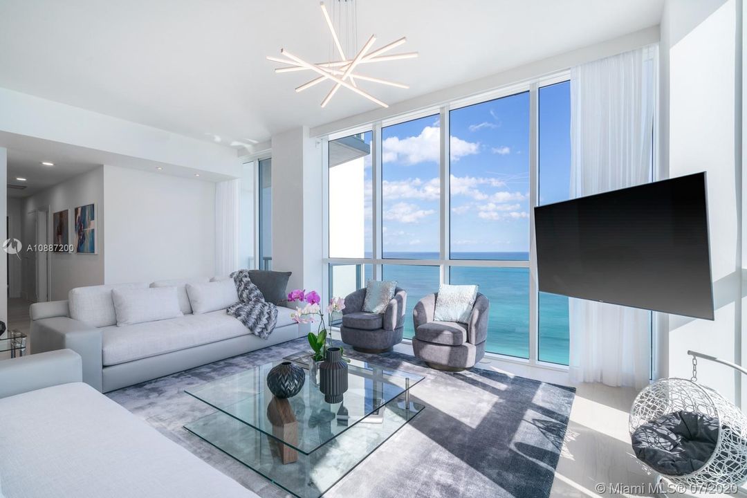 Living room with oceanfront views through 10ft floor-to-ceiling windows