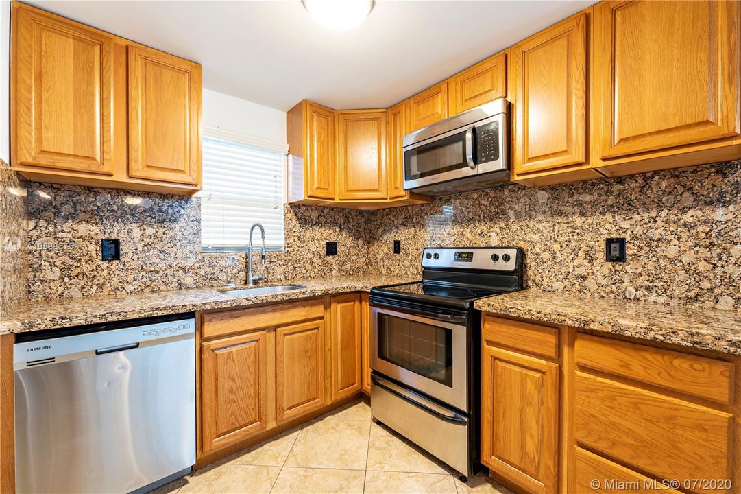 Kitchen featuring granite countertops & stainless steel appliances
