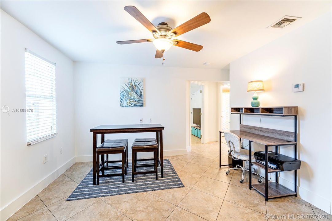 Dining room off the kitchen with view to 2nd bedroom & bath