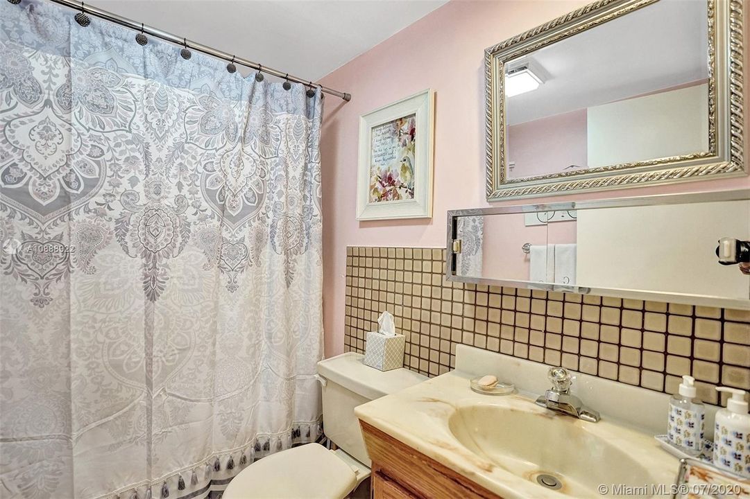 Washer/dryer in half bathroom behind curtain. All of these units were done this way (per seller).