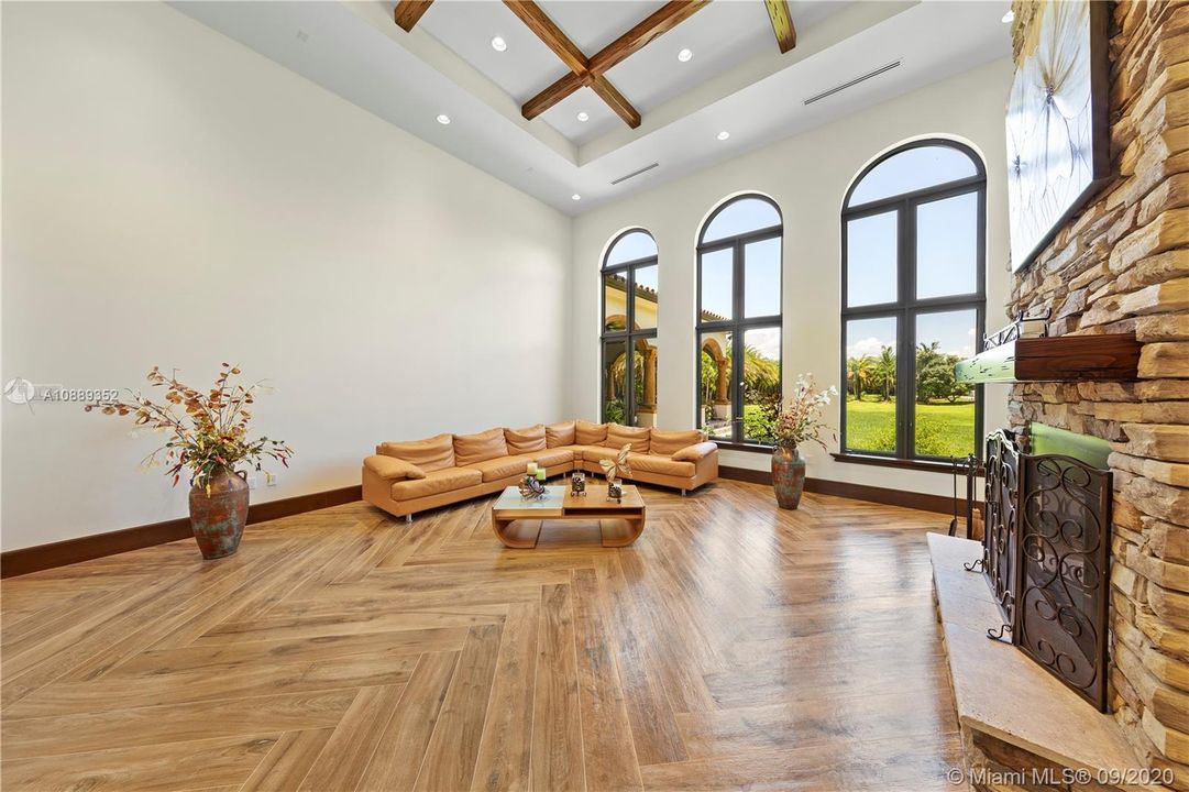 LIVING ROOM WITH PORCELIN  HERRING BONE PATTERN FLOOR WILL OVER FUTURE POOL AREA? THE BUILDING IN WINDOW IS SUMMER KITCHEN.  GREAT CEILING HEIGHTS WITH PECKY CYPRESS CARRIED THRU OUT .