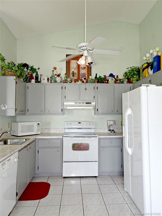 Kitchen has lots of cabinets and newer appliances