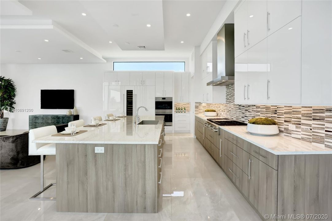 Custom wood cabinetry. 54in upper cabinets. Quartz countertops. Walk in pantry & double wine cooler between double sub zeros.