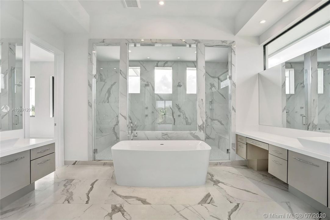 His & her toilets. 36inch vanities with quartz countertops and backsplash. Rectified tile. Frameless clear glass shower door with polished chrome. Counter mount sinks.