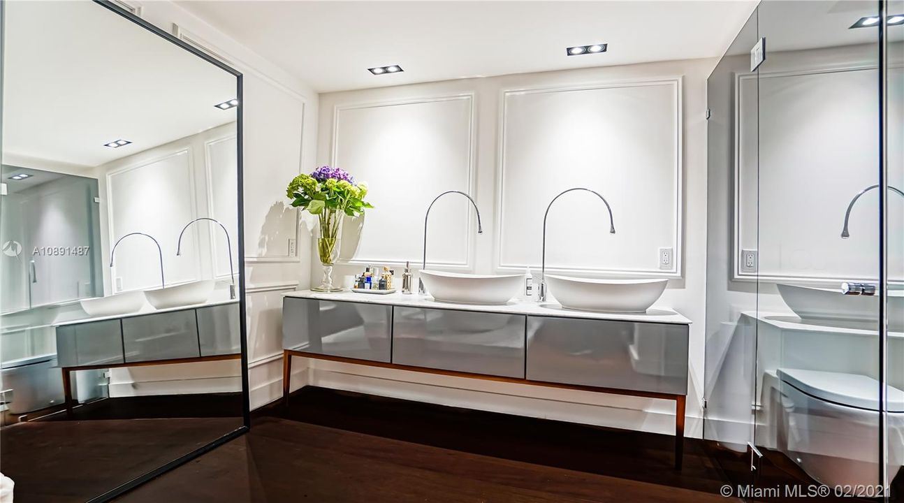 Master Bathroom elegant detail: dual countertop washbasin and Gessi Goccia faucets.