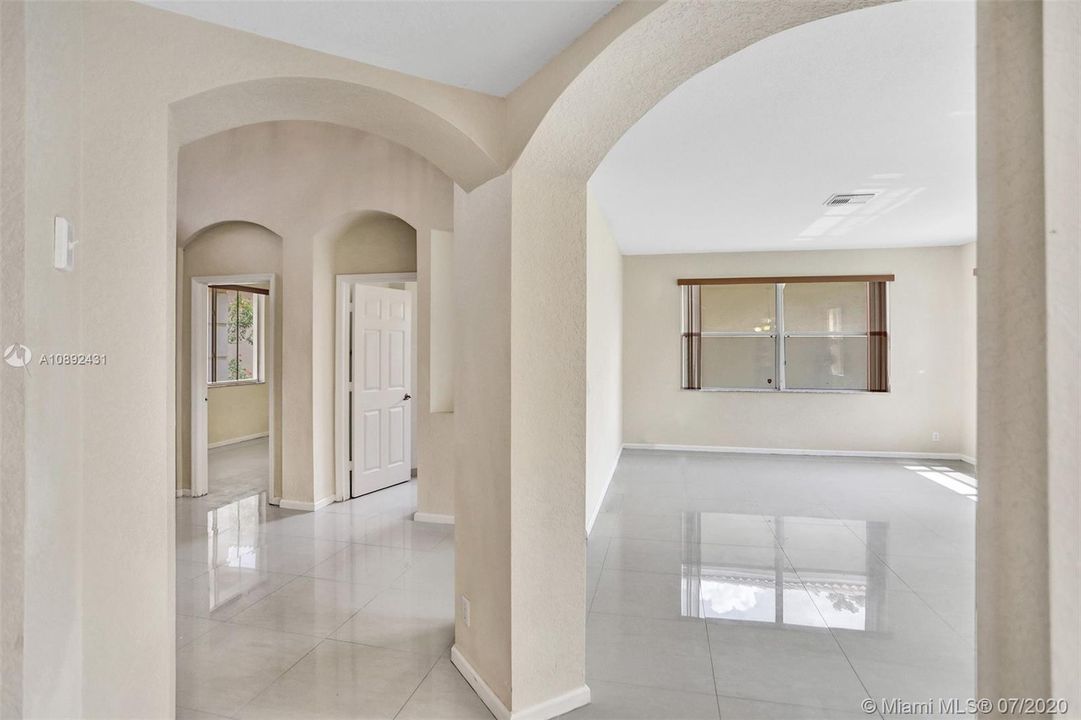 View from family room into foyer and living room.