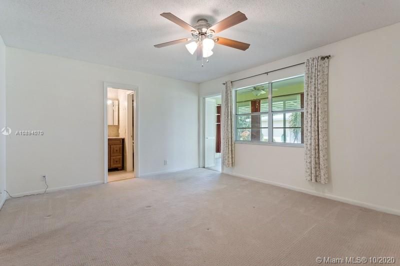 Master bedroom viewed from the walk-in closet. Looking at the master bath and Florida room
