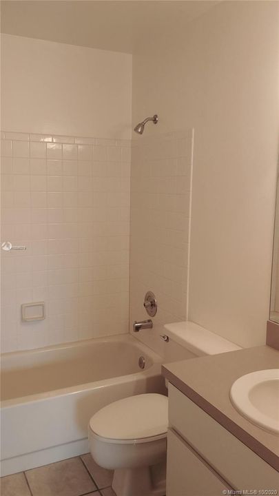 Guest bath with tub and shower. There is a linen closet in hallway.