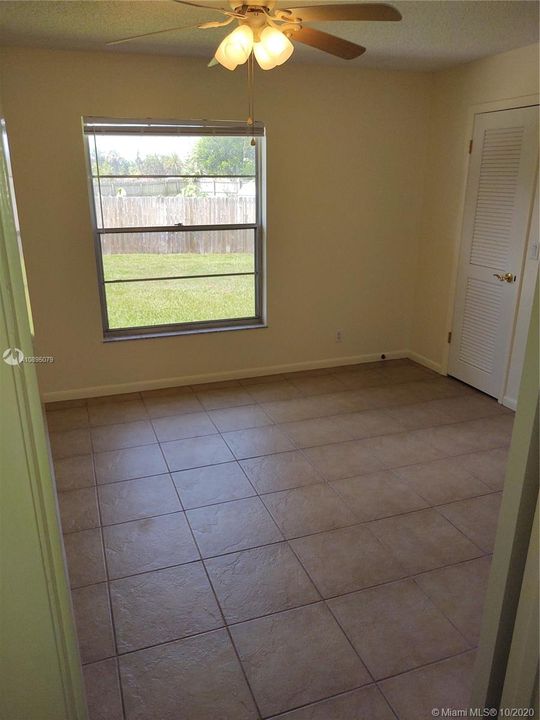 Master Bedroom, well lit with ceiling fan and walk in closet.