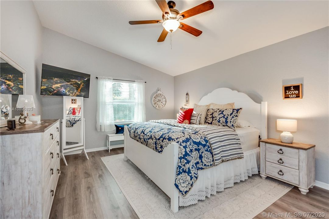 Master Suite fit for a king size bed with plank flooring