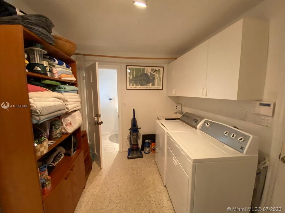 LAUNDRY ROOM - DOOR LEADS INTO GUEST HALF BATH AND OUT TO THE PATIO AREA