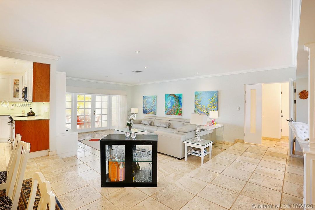 Living area. Kitchen on the left, double doors to the pool area and 3 bedrooms, 2 baths on the right side.