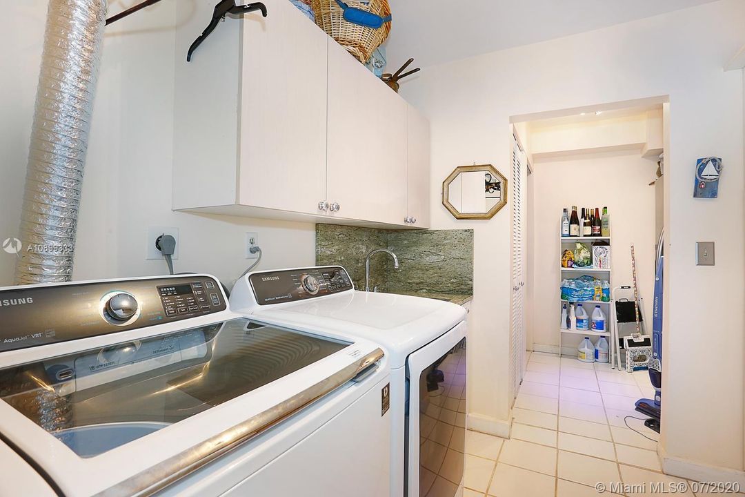 Separate laundry area off of the kitchen within the air conditioned space of the home.