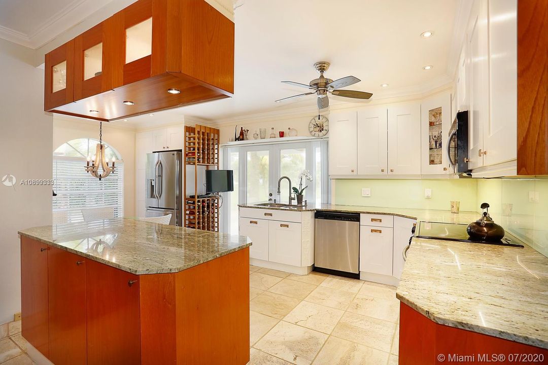 A wonderful kitchen with doors that open up to the pool area.