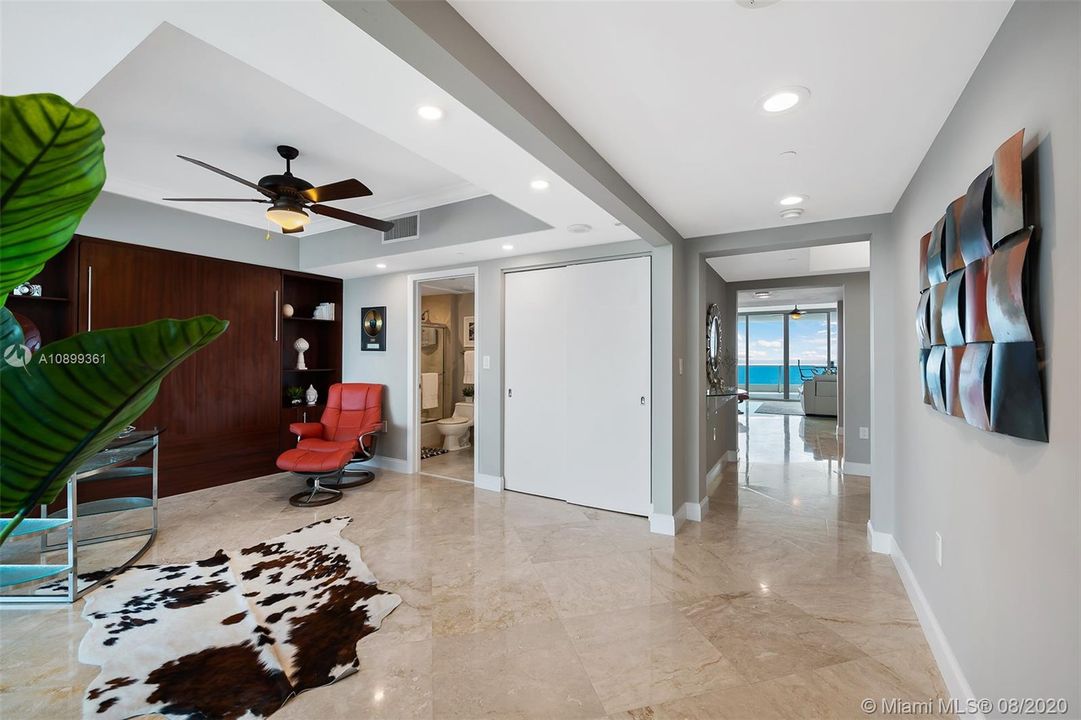 Open guest bedroom with private balcony,  custom murphy bed and ensuite bathroom.