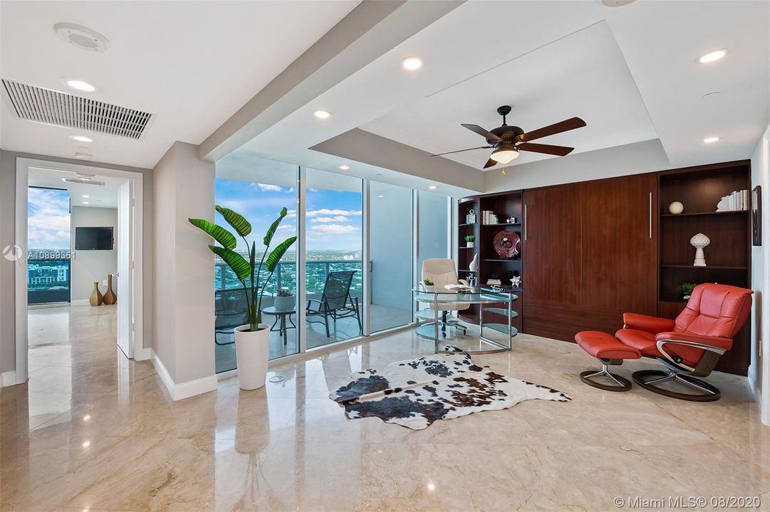 Open guest bedroom with private balcony and custom murphy bed.