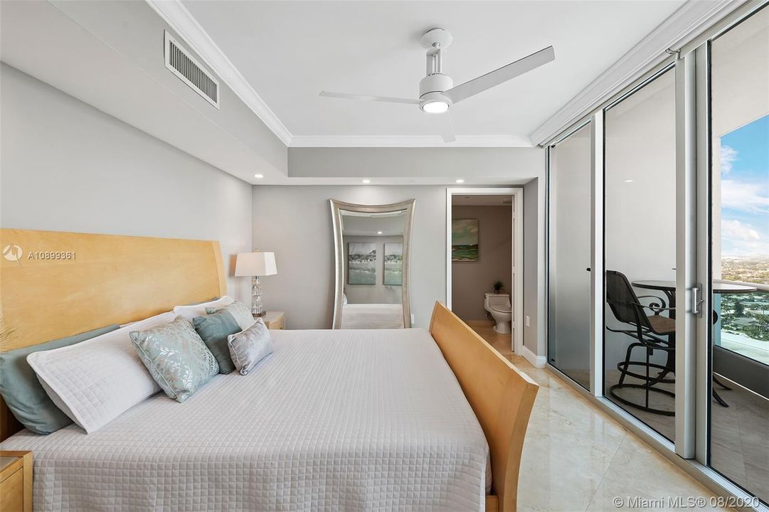 Guest bedroom with ensuite bathroom, spacious closet with built ins and electronic shades.