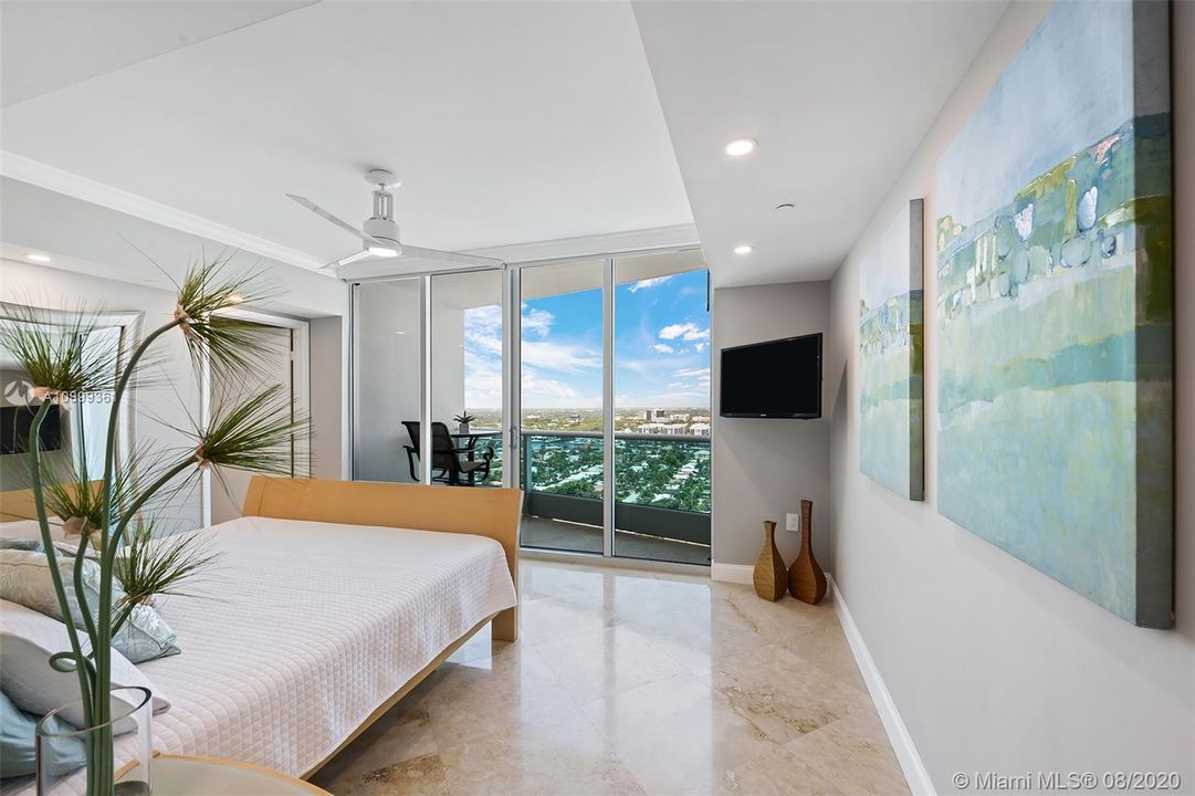 Guest bedroom with ensuite bathroom, spacious closet with built ins and electronic shades.