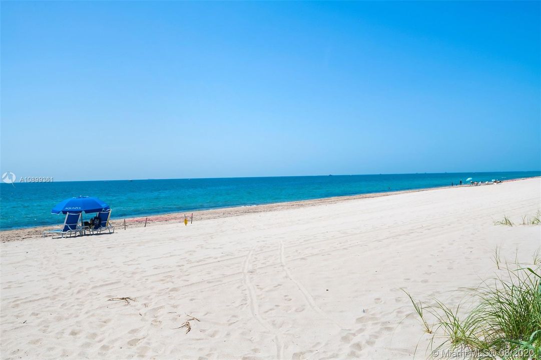 Private beach access with Aquazul umbrellas and beach attendant