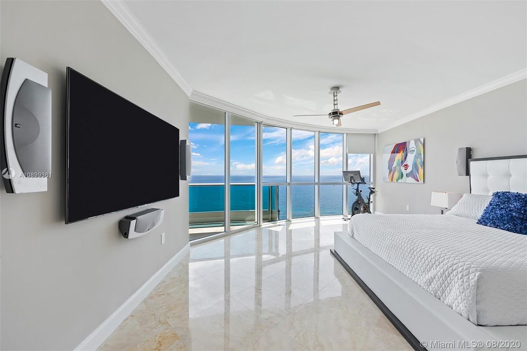 Stunning 18 by 18 master suite with floor to glass windows, surround sound, and electronic shades.  Direct ocean views all day!