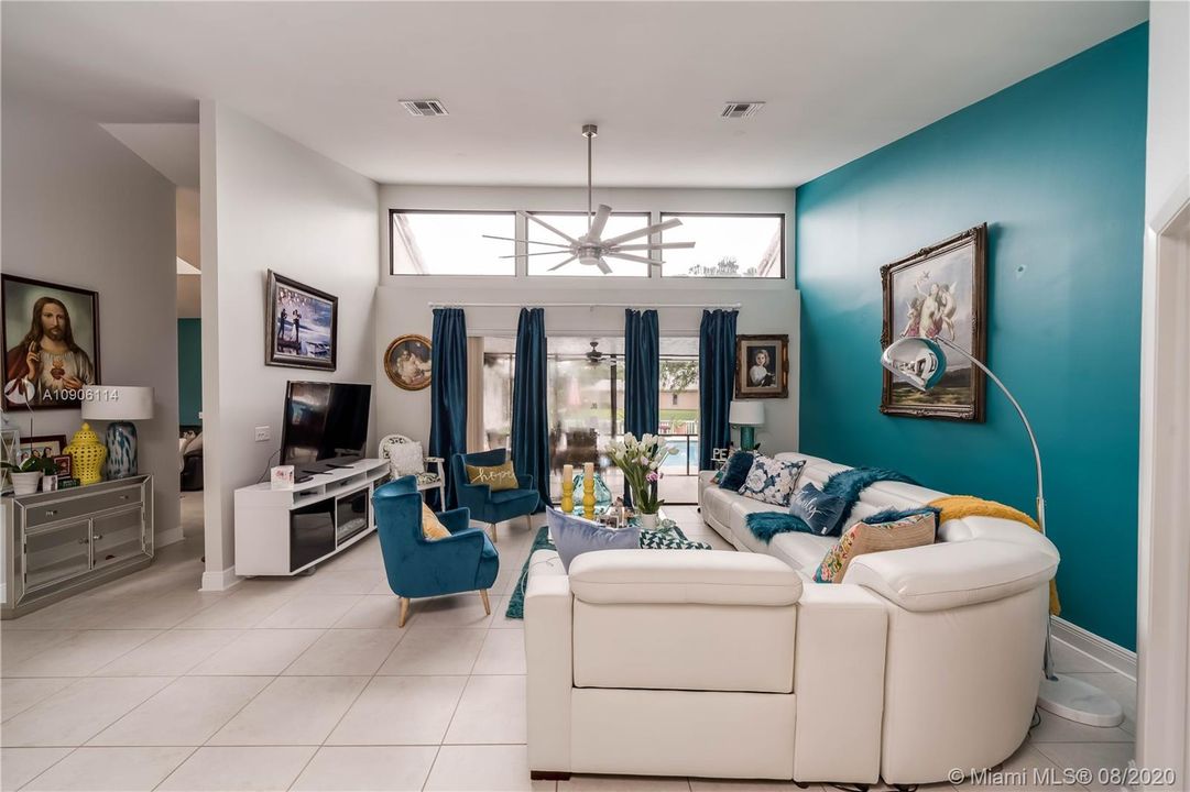 View from front door looking into living room, with wall of windows to Screened patio & pool beyond. Upper windows, Impact Glass