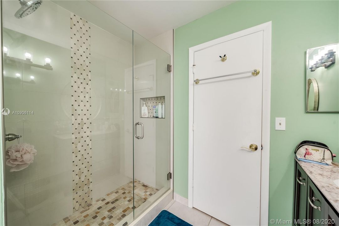 Guest Bath shower with custom tiling and seamless glass enclosure