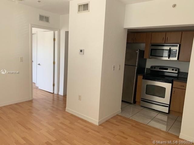 KItchen and living room. Entrance to bedroom.