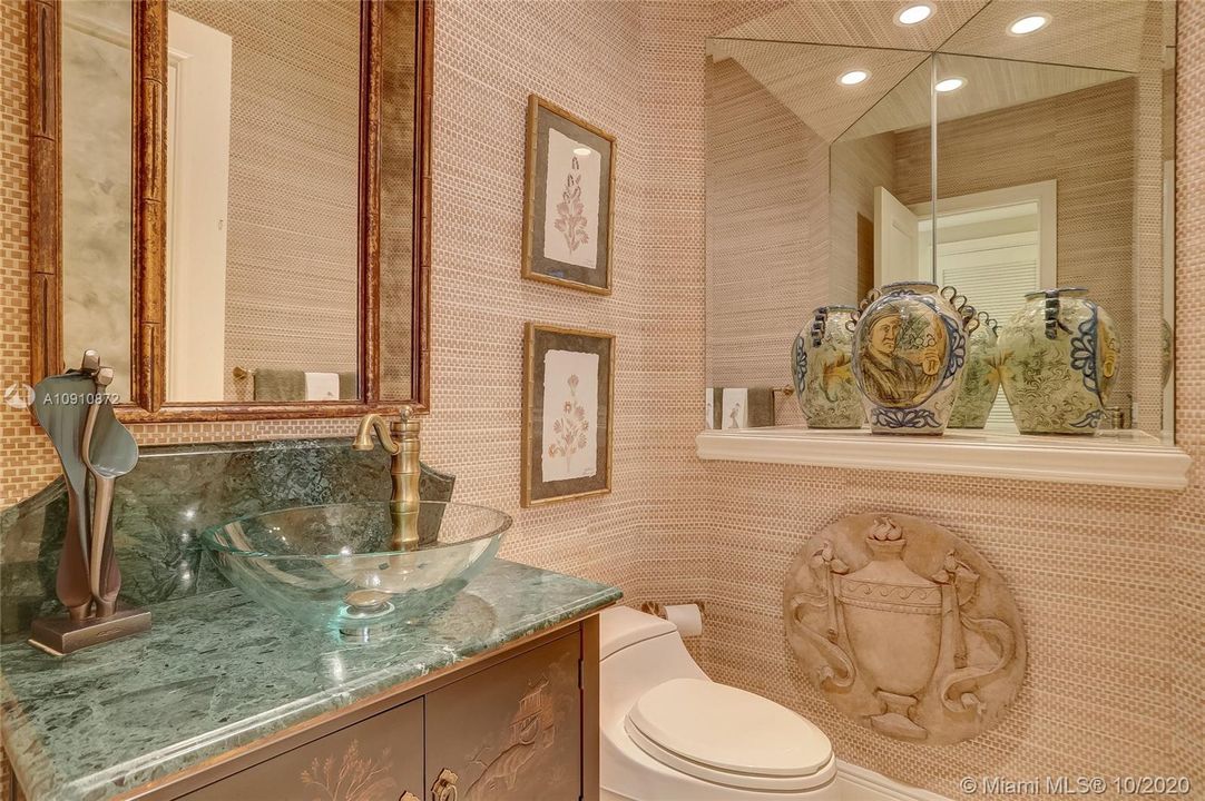 Downstairs Powder Room w/ wicker wall coverings, designed by decorator