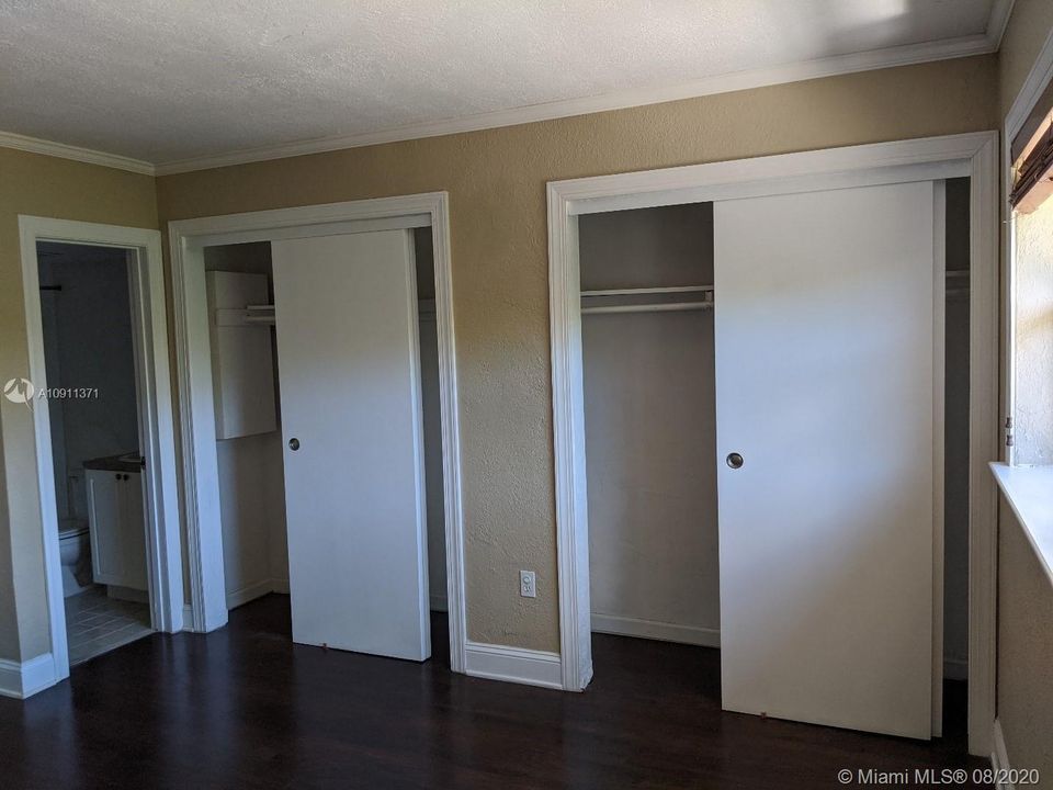 Bedroom Has Entire Wall of Closets
