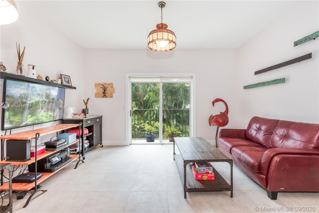 Living Room with balcony and view of private backyard