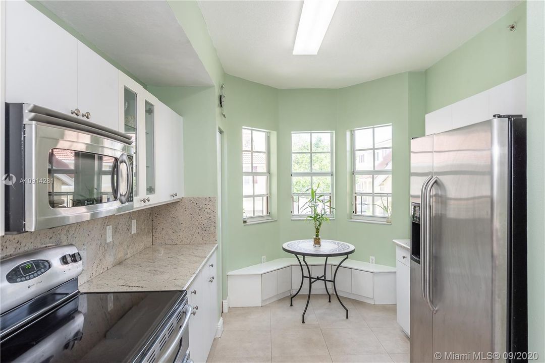 Kitchen with granite countertops and SS appliances, breakfast nook and bay window