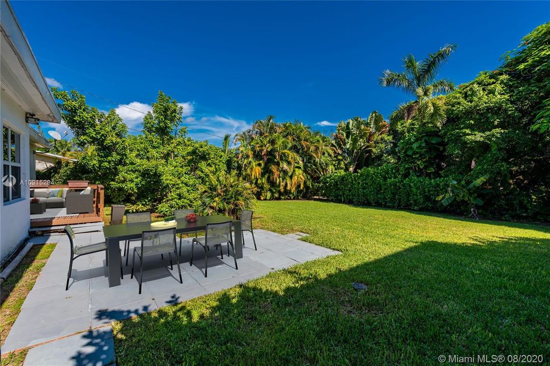 Large fenced back yard with patio & deck - virtually staged