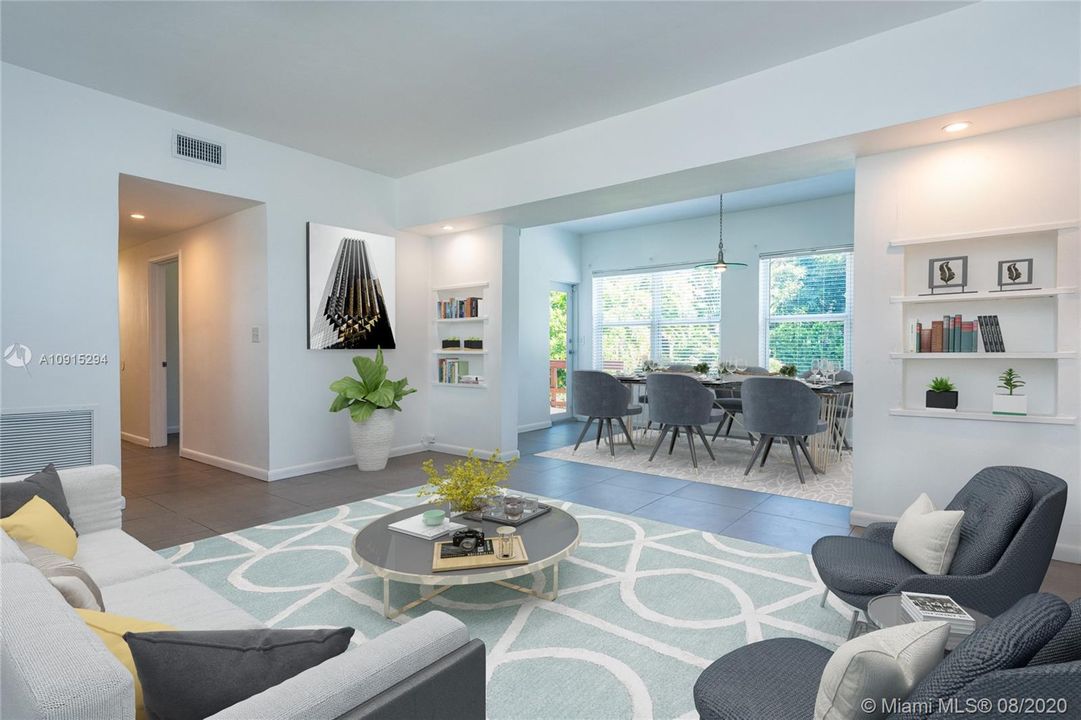 Living room & dining room w/recessed shelves w/lighting + high 9' tall ceilings, all impact windows & doors - virtually staged