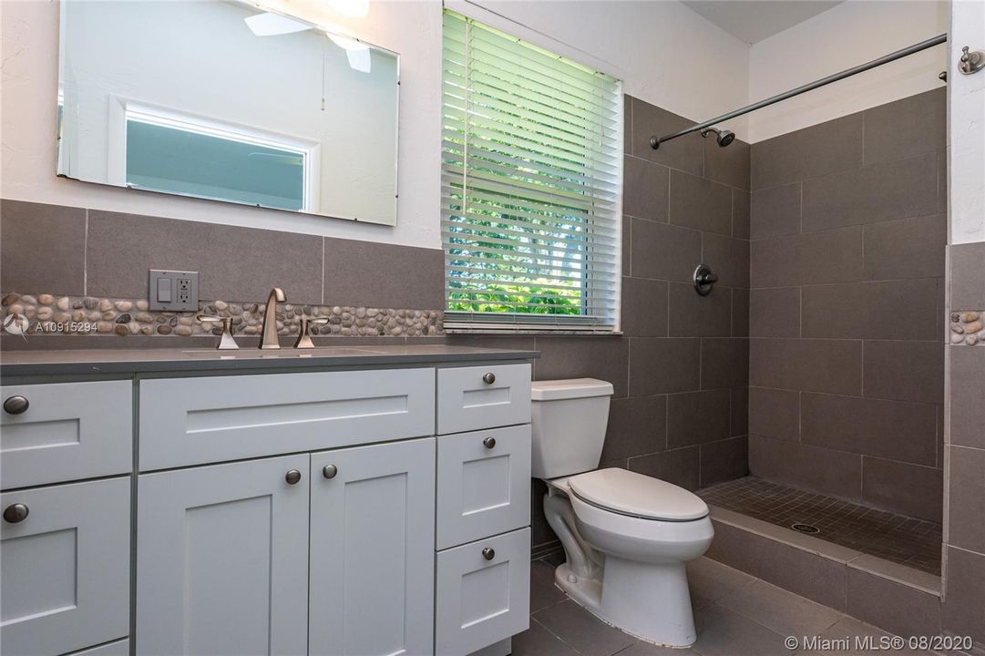 Large master bathroom with oversized shower en suite with bedroom