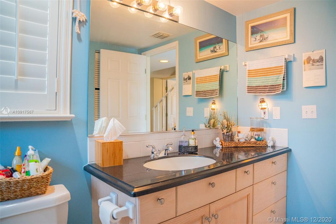 ONE OF THE BATHROOMS: GRANITE COUNTER, PLANTATION SHUTTERS