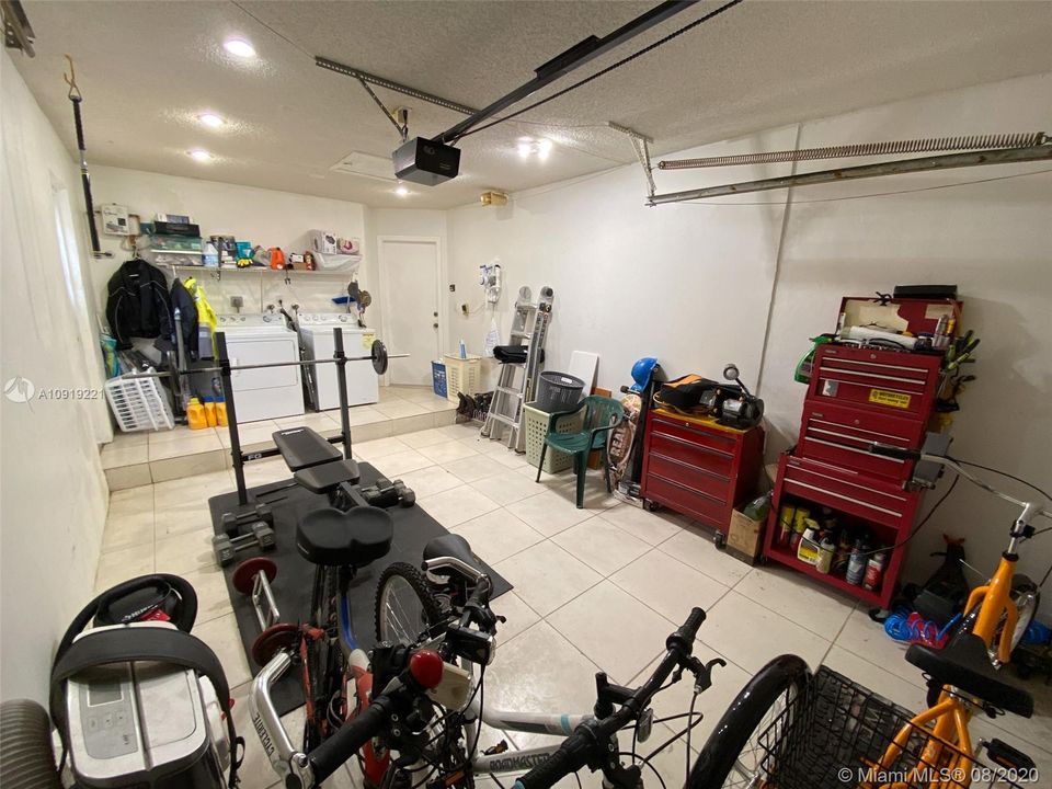 Single car garage with side door on the left. Door on right leads to home interior.
