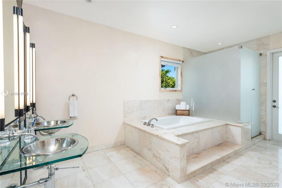 MASTER BATHROOM WITH BATHTUB AND SHOWER.