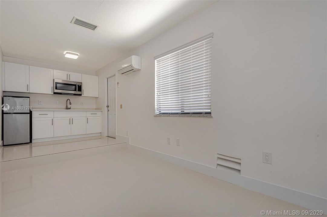 Efficiency / in-law quarters kitchen equipped with microwave and refrigerator