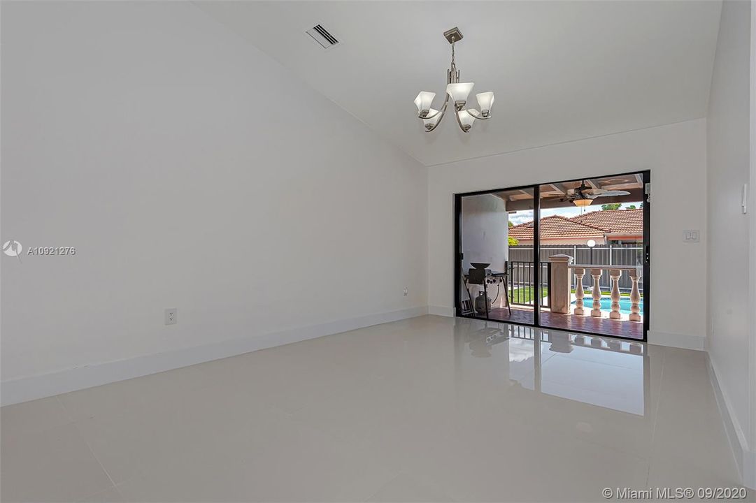 Dining room features sliding glass doors with access to the pool and yard area