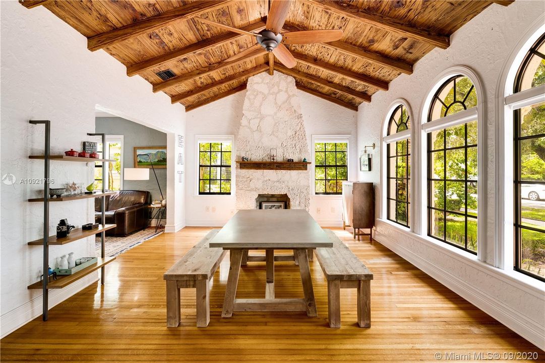 Stone wood-burning fireplace anchors the room
