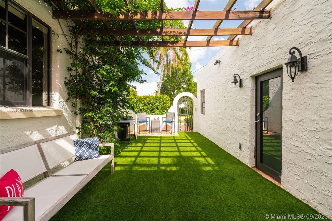 Courtyard features artificial turf for easy living