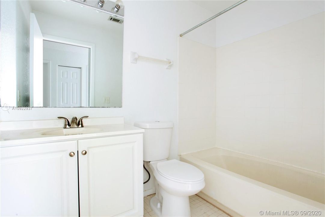 Hallway bathroom with tub