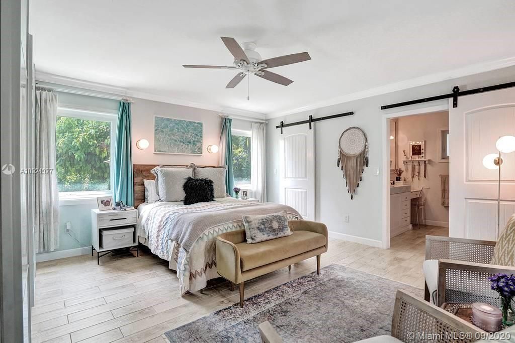 Master bedroom with view of the private backyard and pool