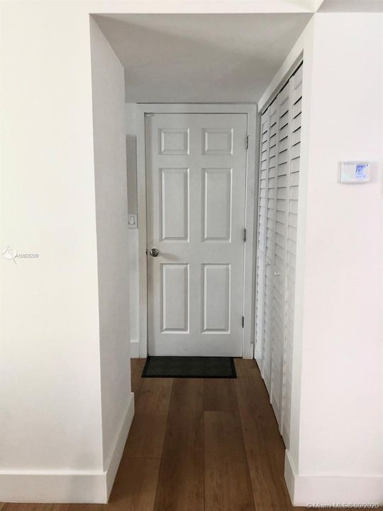Hallway off the kitchen area, door into the garage ( washer and dryer in the garage).